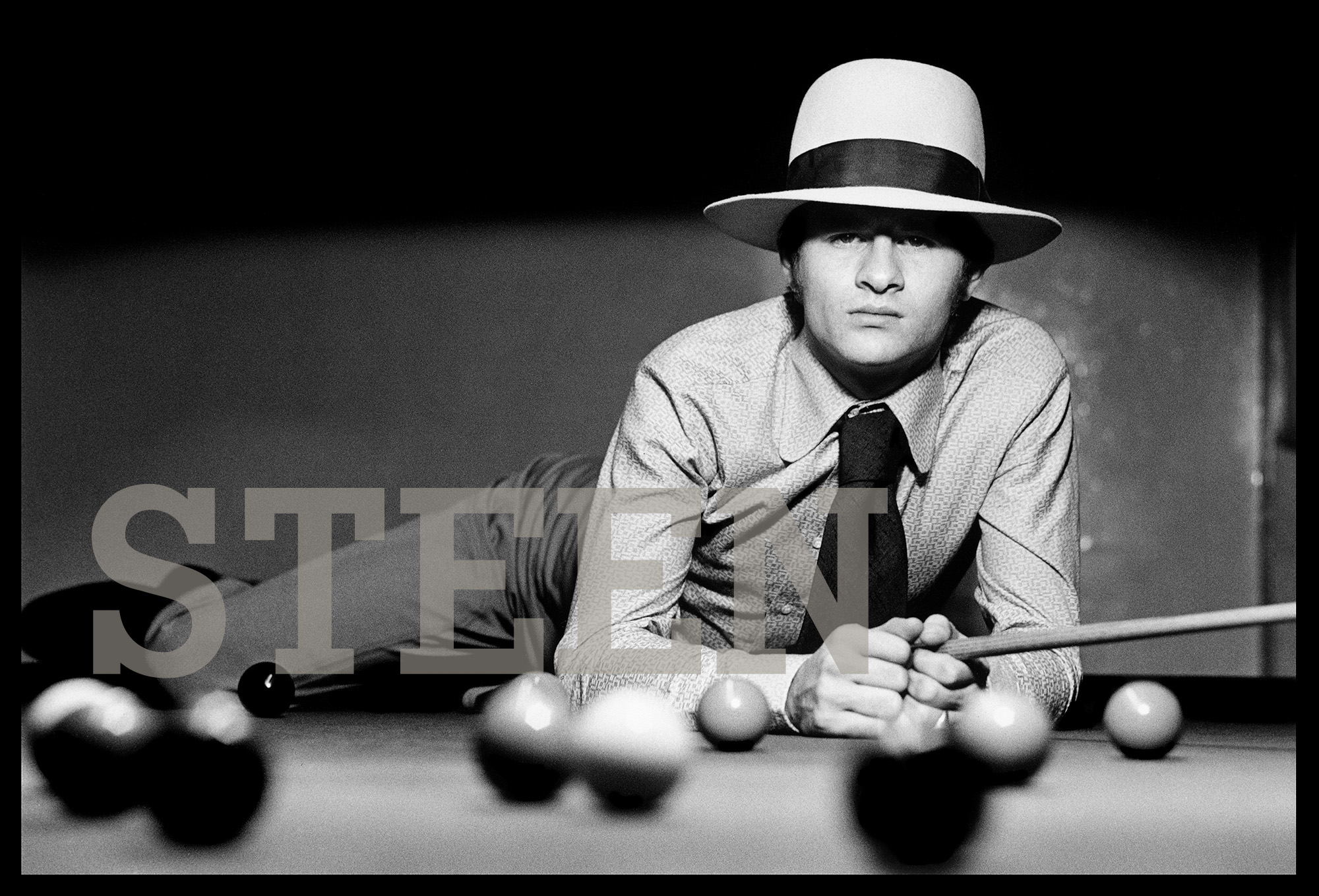 an exclusive black and white photograph of alex hurricane higgins leaning across a snooker table by british photographer david steen