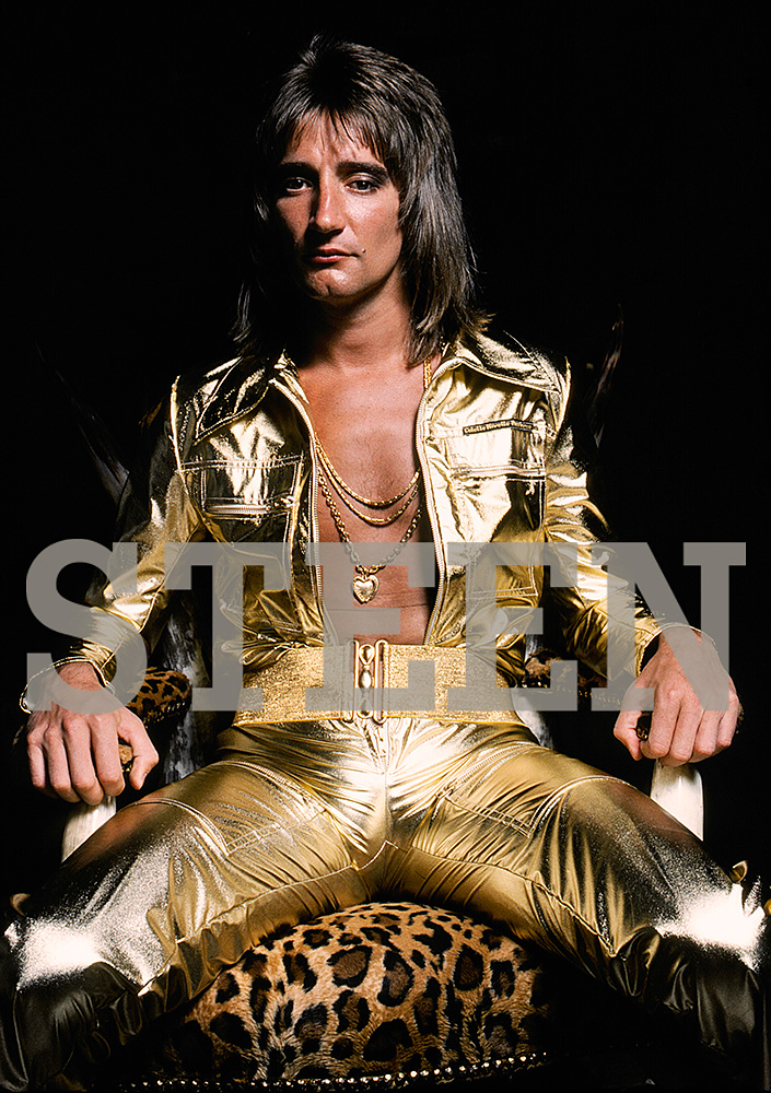 exclusive photograph of rod stewart wearing a gold all in one jumpsuit on a leopard skin chair by british photographer david steen